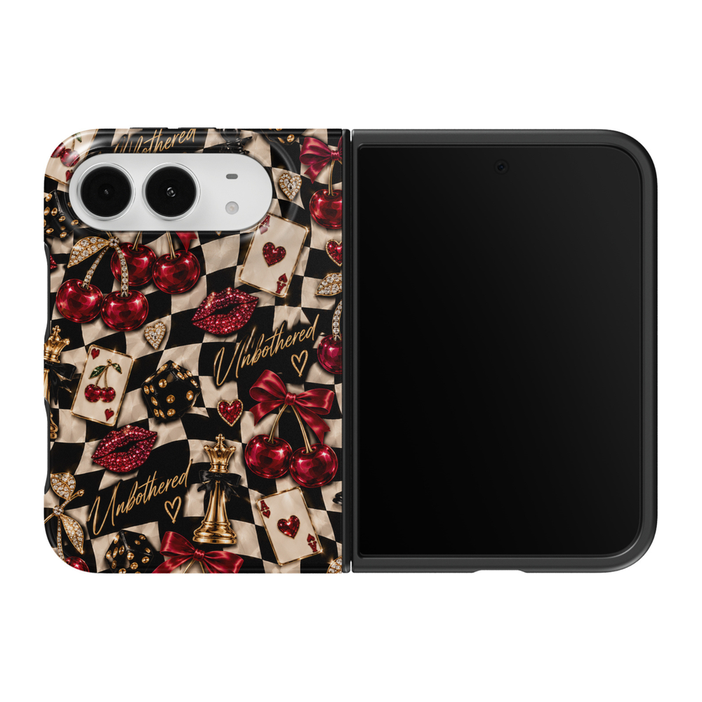 CASELIX Cherry Checkmate iPhone Duo Tough MagSafe folding phone case featuring a bold black and cream checkerboard pattern decorated with ruby-red jeweled cherries, sparkling red lipstick kisses, burgundy satin bows, gold chess pieces, black dice with gold details, heart-themed playing cards, and elegant Unbothered script lettering. Trendy cherry checkerboard phone case for women with a glossy printed finish, glamorous Y2K aesthetic, edgy coquette fashion, chic nightlife-inspired artwork, and protective two