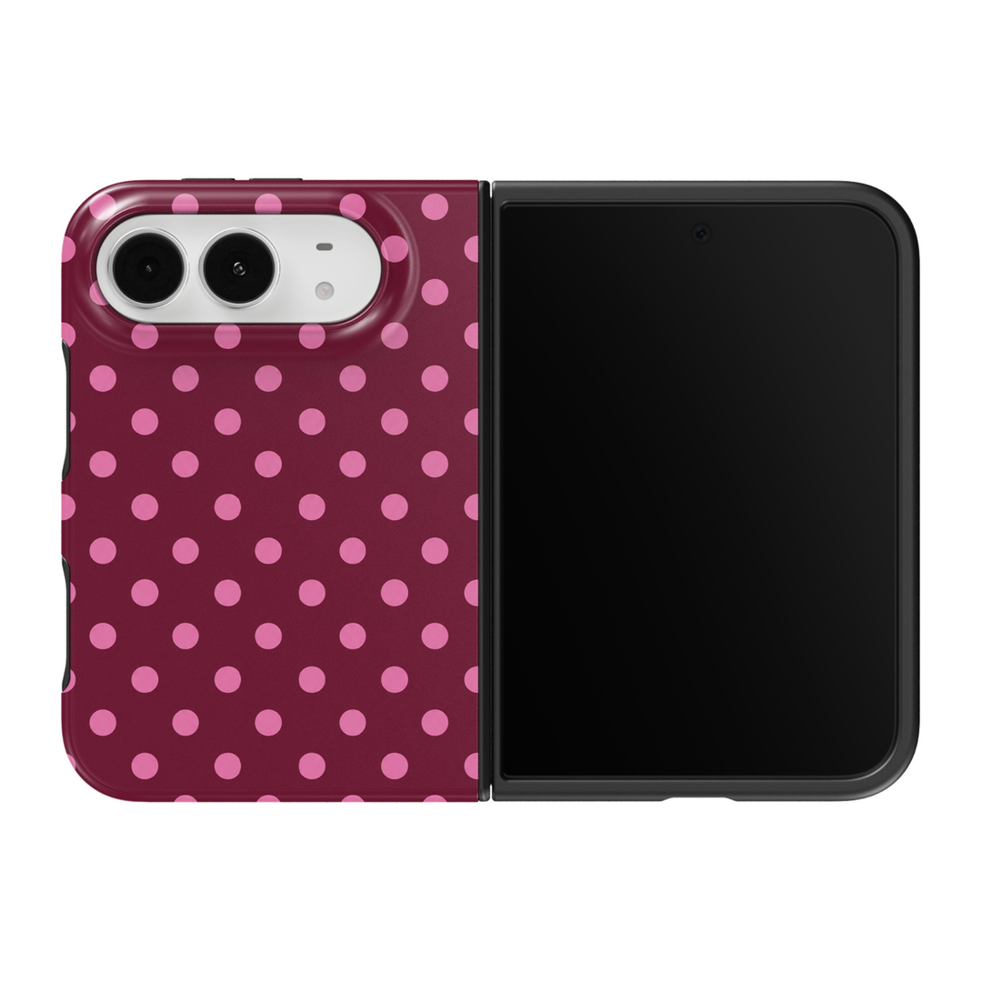 CASELIX Berry Polka iPhone Duo Tough MagSafe folding phone case featuring a rich burgundy and deep berry background decorated with evenly spaced bubblegum-pink polka dots in a classic repeating pattern. Trendy burgundy and pink dotted phone case for women with a glossy printed finish, feminine retro-chic aesthetic, playful preppy fashion, minimalist geometric design, vintage-inspired polka dot artwork, and protective two-piece foldable construction.