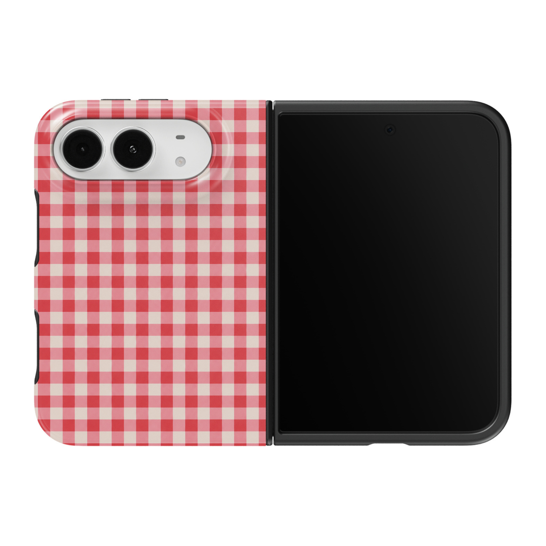 CASELIX Cherry Gingham iPhone Duo Tough MagSafe folding phone case featuring a classic cherry-red, soft pink, and ivory-white gingham checkered pattern with evenly spaced woven-style squares. Trendy red gingham phone case for women with a glossy printed finish, feminine cottagecore aesthetic, vintage picnic-inspired plaid design, retro preppy fashion style, minimalist geometric checks, and protective two-piece foldable construction.