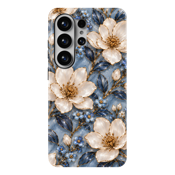 CASELIX Sapphire Magnolia Samsung Galaxy S26 Ultra Tough MagSafe protective phone case featuring a luxurious dusty sapphire-blue background adorned with large, luminous ivory-white magnolia blossoms, delicate powder-blue flowers, and elegant deep navy botanical leaves. Intricate metallic gold-inspired outlines accentuate the pearlescent flower petals, golden floral centers, graceful stems, and delicate unopened buds, creating a sophisticated jewel-tone floral aesthetic. The romantic repeating pattern combin
