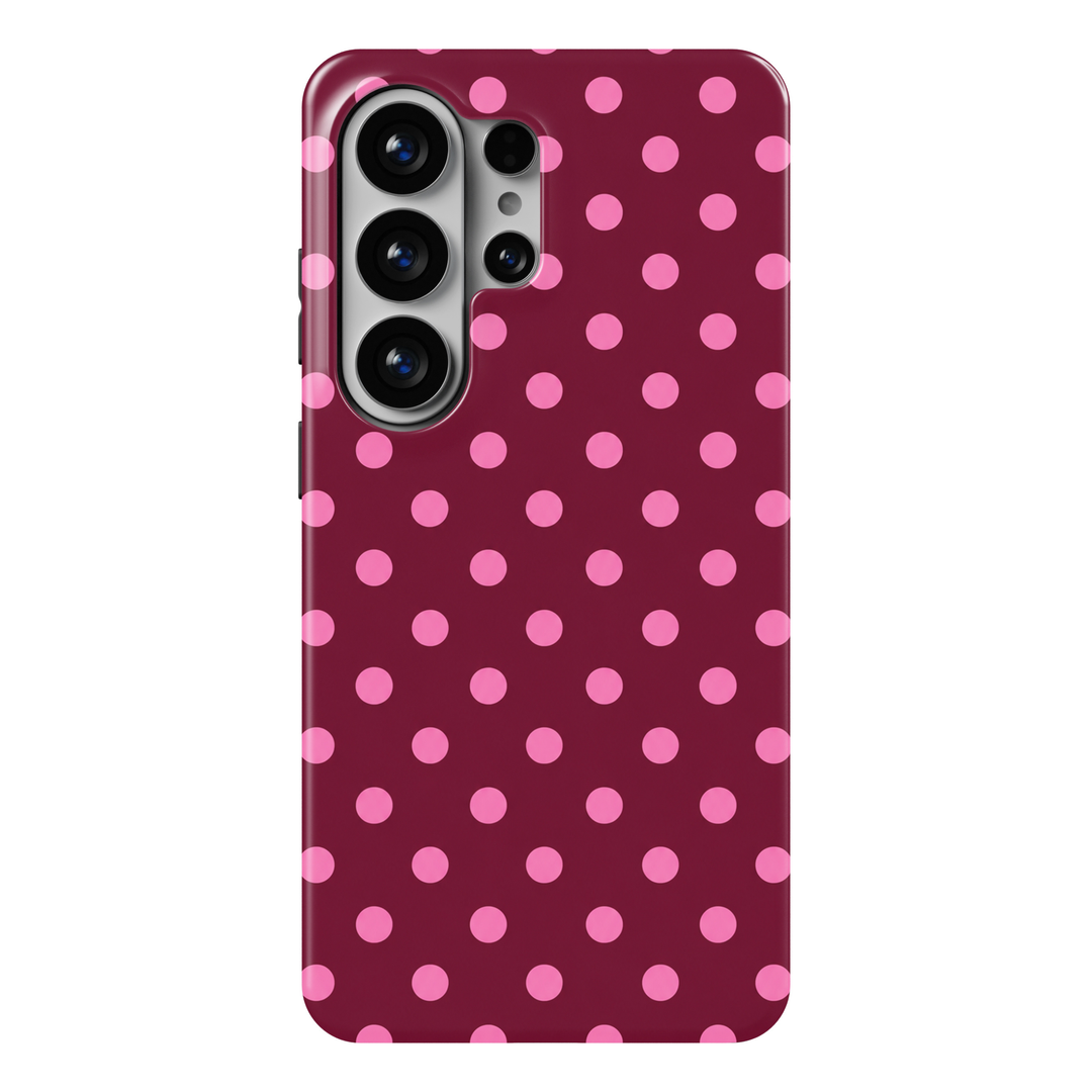 CASELIX Berry Pop Samsung Galaxy S26 Ultra Tough MagSafe protective phone case featuring a rich raspberry-burgundy background decorated with playful bubblegum-pink polka dots. The cheerful pink circular dots are evenly spaced in a neat, staggered repeating pattern, creating a bold yet balanced geometric design. Deep berry-wine tones contrast beautifully with vibrant candy-pink accents, giving the case a striking feminine aesthetic inspired by retro fashion, playful preppy style, and modern coquette trends. 