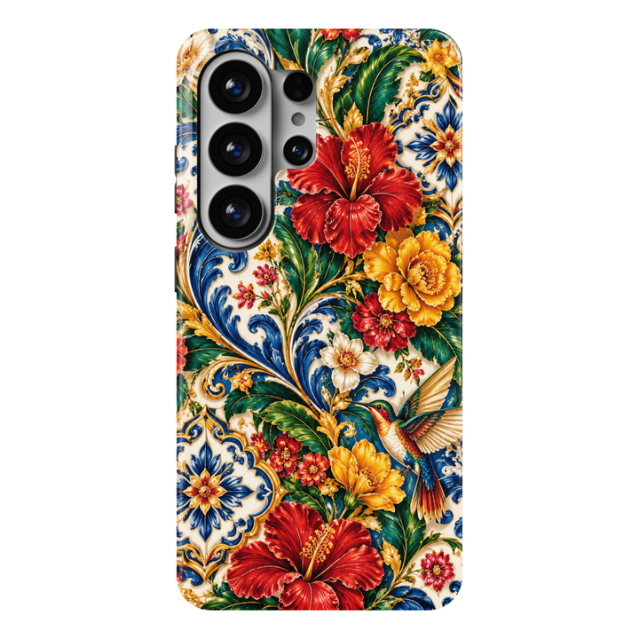 CASELIX Tropical Azulejo Samsung Galaxy S26 Ultra Tough MagSafe protective phone case featuring vibrant crimson-red hibiscus flowers, golden-yellow tropical blossoms, lush emerald-green foliage, and a colorful hummingbird with iridescent turquoise, ruby, and golden feathers. Intricate cobalt-blue Portuguese azulejo-inspired ceramic tile patterns, ornate golden baroque scrollwork, and delicate floral details decorate a warm ivory background. Luxurious Portugal-inspired Galaxy phone case for women with a glos