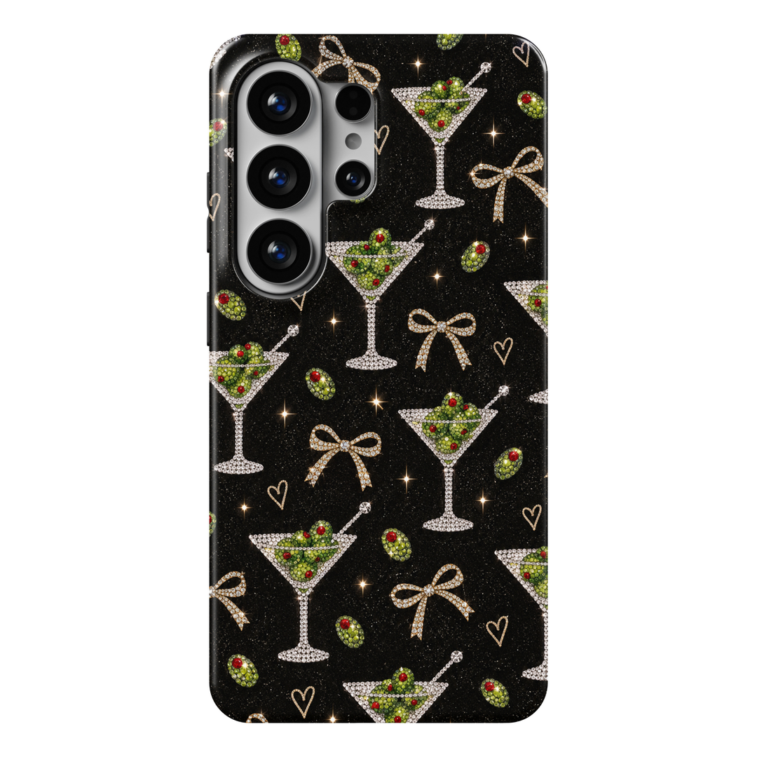 CASELIX Midnight Martini Samsung Galaxy S26 Ultra Tough MagSafe protective phone case featuring a glamorous jet-black background decorated with sparkling rhinestone-inspired martini cocktail glasses filled with brilliant emerald-green olives and ruby-red pimento accents. Elegant champagne-gold jeweled ribbon bows, delicate golden hearts, scattered crystal-inspired olives, and shimmering starbursts create a luxurious cocktail party aesthetic. The sophisticated repeating pattern combines dazzling diamond-like