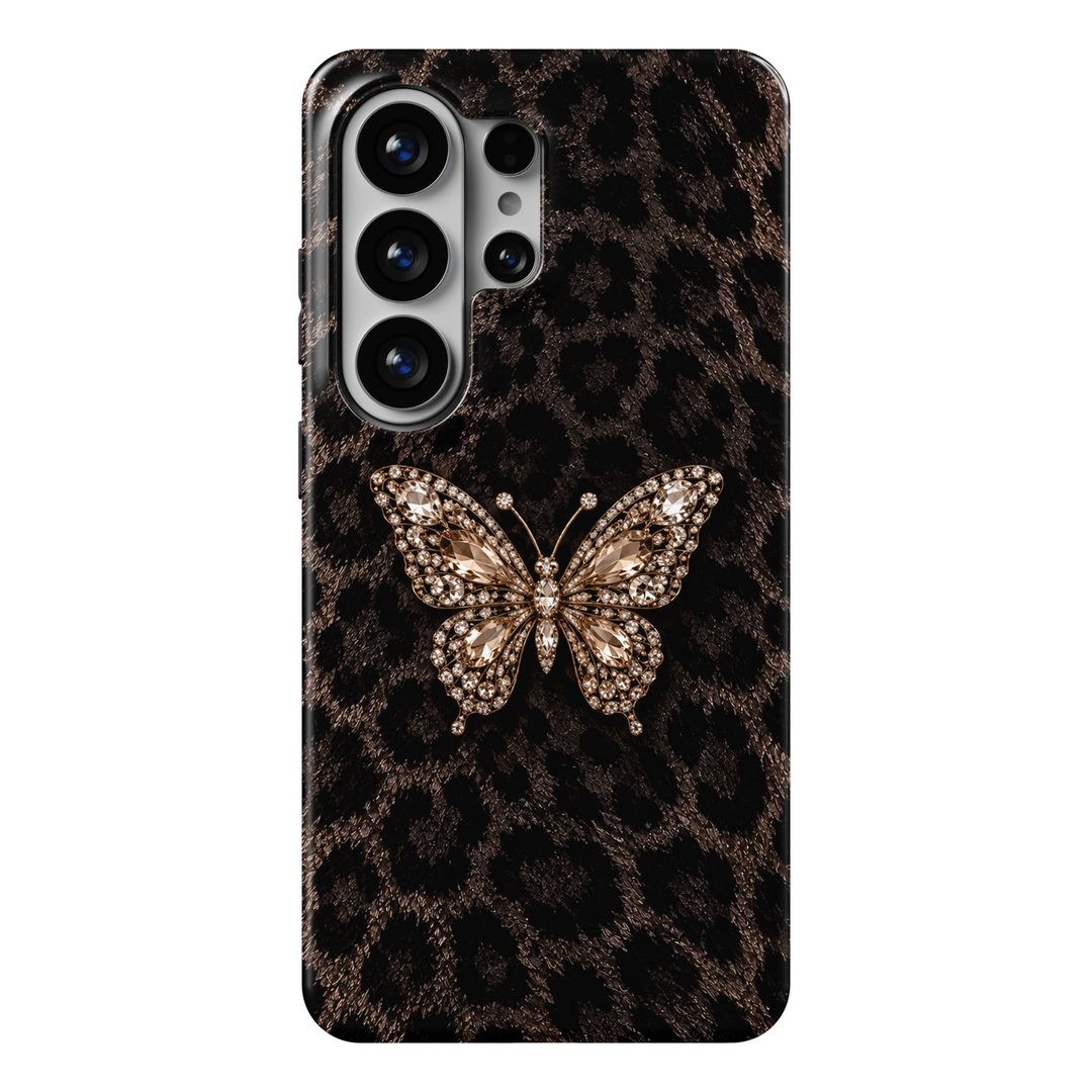 CASELIX Midnight Butterfly Luxe Samsung Galaxy S26 Ultra Tough MagSafe protective phone case featuring a luxurious dark chocolate-brown and black leopard print background adorned with an elegant champagne-gold jeweled butterfly centerpiece. The sophisticated design showcases irregular black leopard spots against a richly textured espresso-brown, faux-fur-inspired surface, creating a dramatic and fashionable animal print aesthetic. At the center, a magnificent butterfly features intricately detailed wings em
