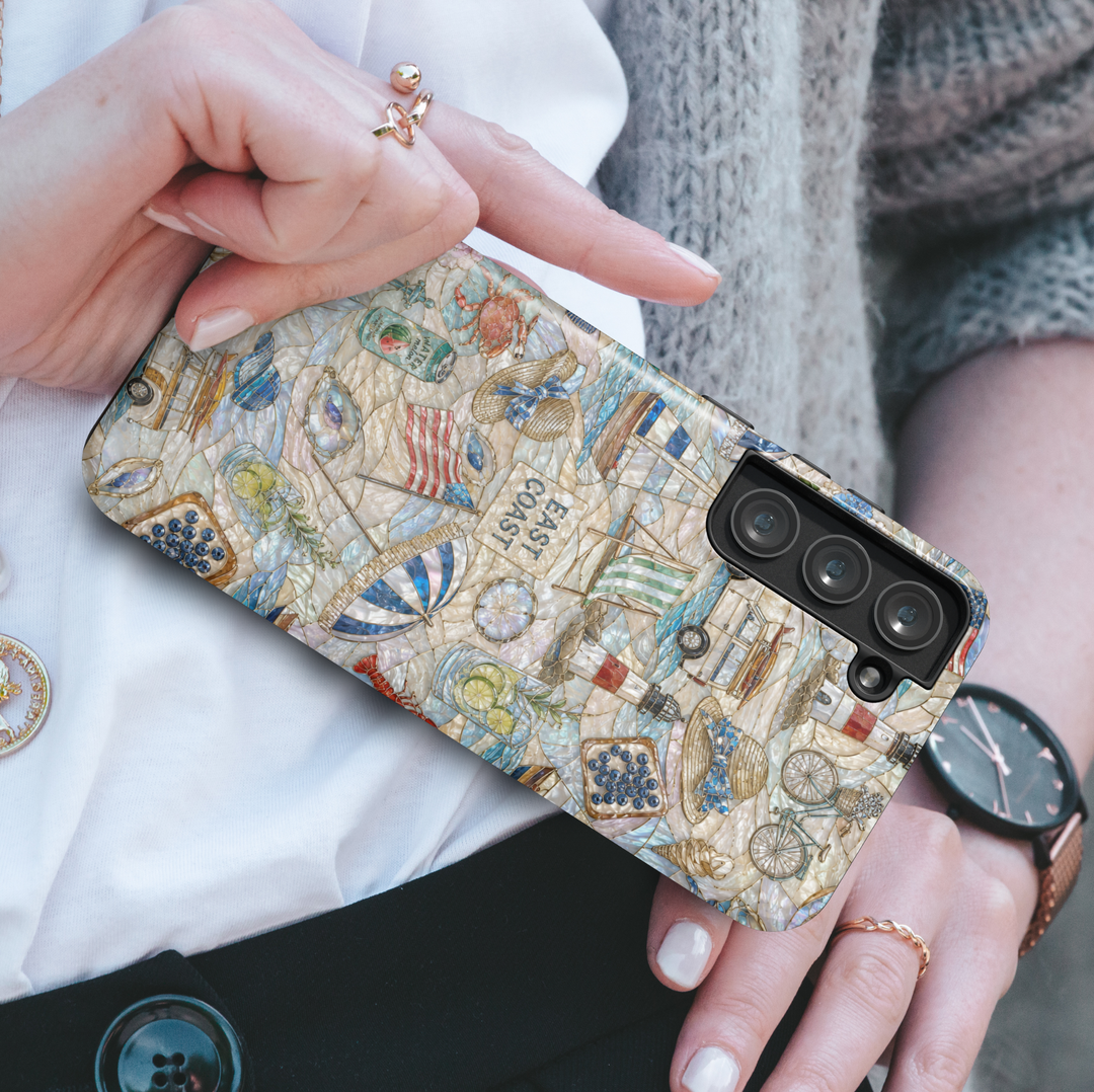 Coastal Samsung Galaxy case featuring ocean waves, tropical beach scenery, seashells, pearl accents, palm trees, and seaside sunset artwork.