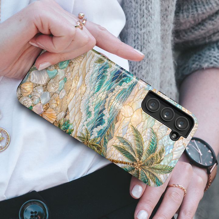 Coastal Samsung Galaxy case featuring ocean waves, tropical beach scenery, seashells, pearl accents, palm trees, and seaside sunset artwork.