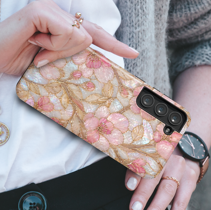 Pink floral Samsung Galaxy S26 Ultra case with iridescent pearl texture and gold outline flower design.