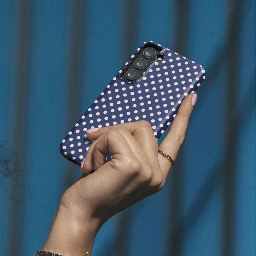 Navy blue polka dot personalized phone case with custom name on a protective iPhone and Samsung Galaxy phone case