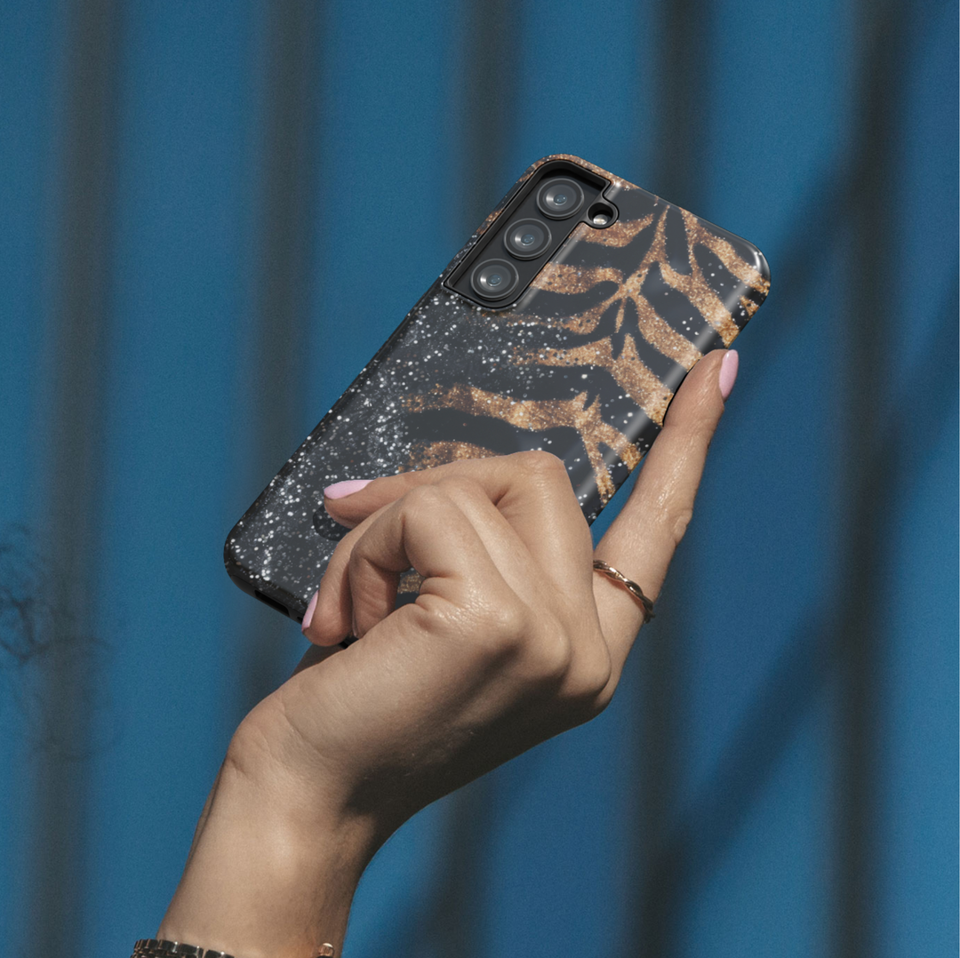 Black and gold leopard luxury phone case with glitter accents on a protective iPhone and Samsung Galaxy phone case for women