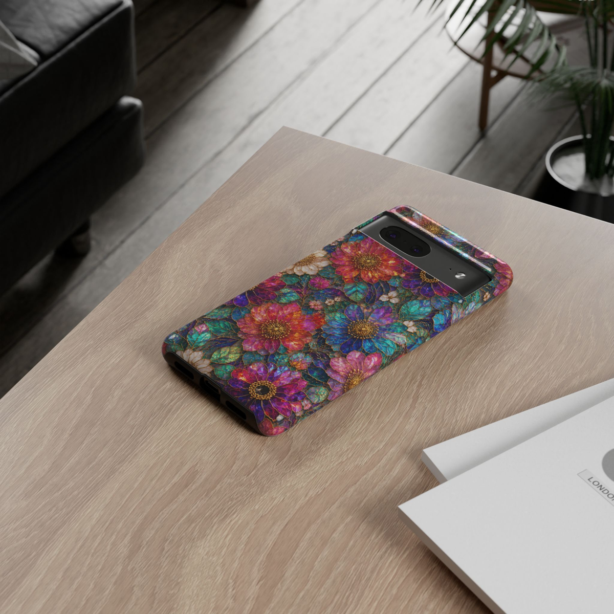 Protective Google Pixel 10 Pro phone case featuring vibrant jewel-toned flowers in blue, purple, pink, teal, and gold with a luxurious stained-glass botanical design and durable dual-layer protection.