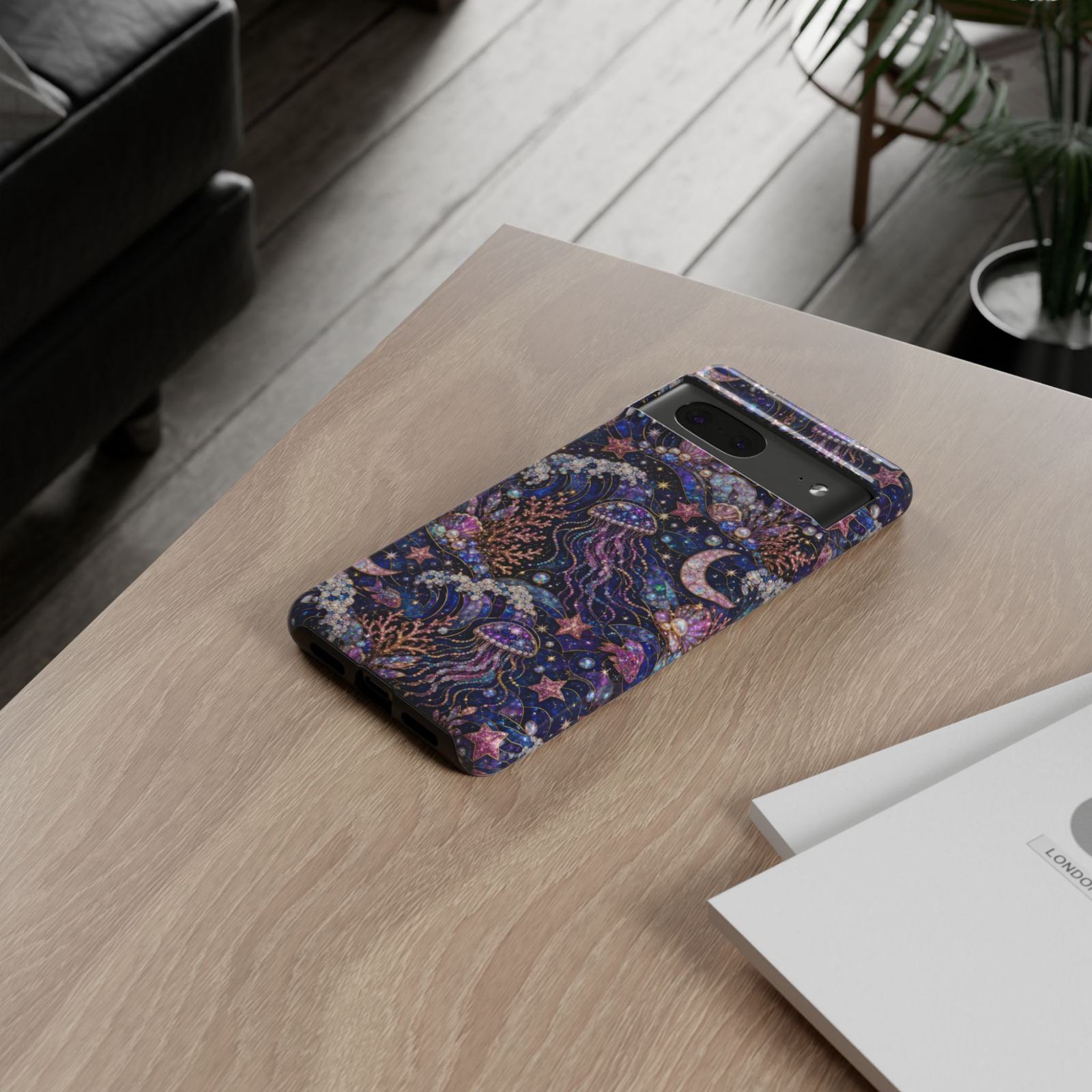 Protective Google Pixel 10 Pro phone case featuring shimmering jellyfish, moonlit ocean waves, coral, pearls, seashells, stars, and celestial artwork in deep blue and purple tones with durable dual-layer protection.
