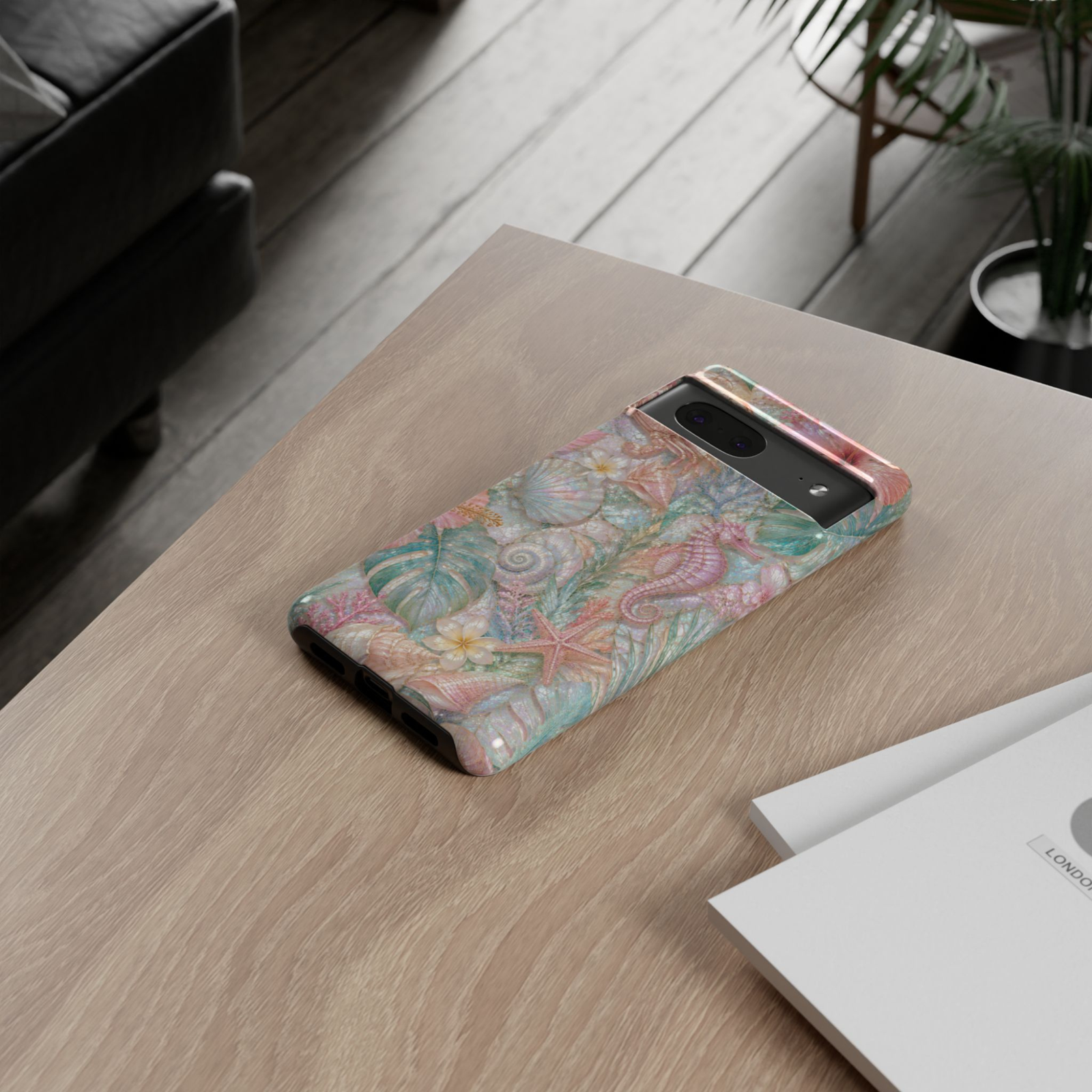Google Pixel 10 Pro protective phone case featuring a pink seahorse with seashells, starfish, tropical leaves, coral, and shimmering pearl ocean artwork on a durable dual-layer case.