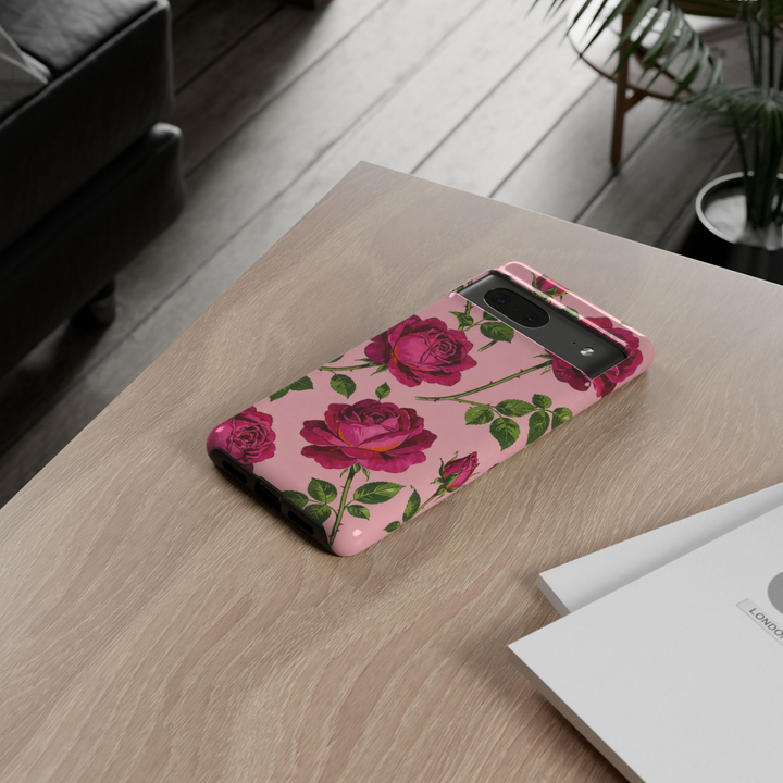 Google Pixel 10 Pro protective phone case featuring vintage magenta roses with green leaves on a blush pink background, offering durable dual-layer protection and elegant botanical style.