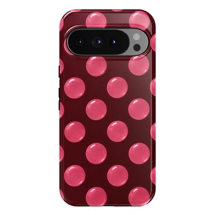 Pink Pop Google Pixel phone case featuring oversized glossy bubblegum pink polka dots on a deep burgundy red background.