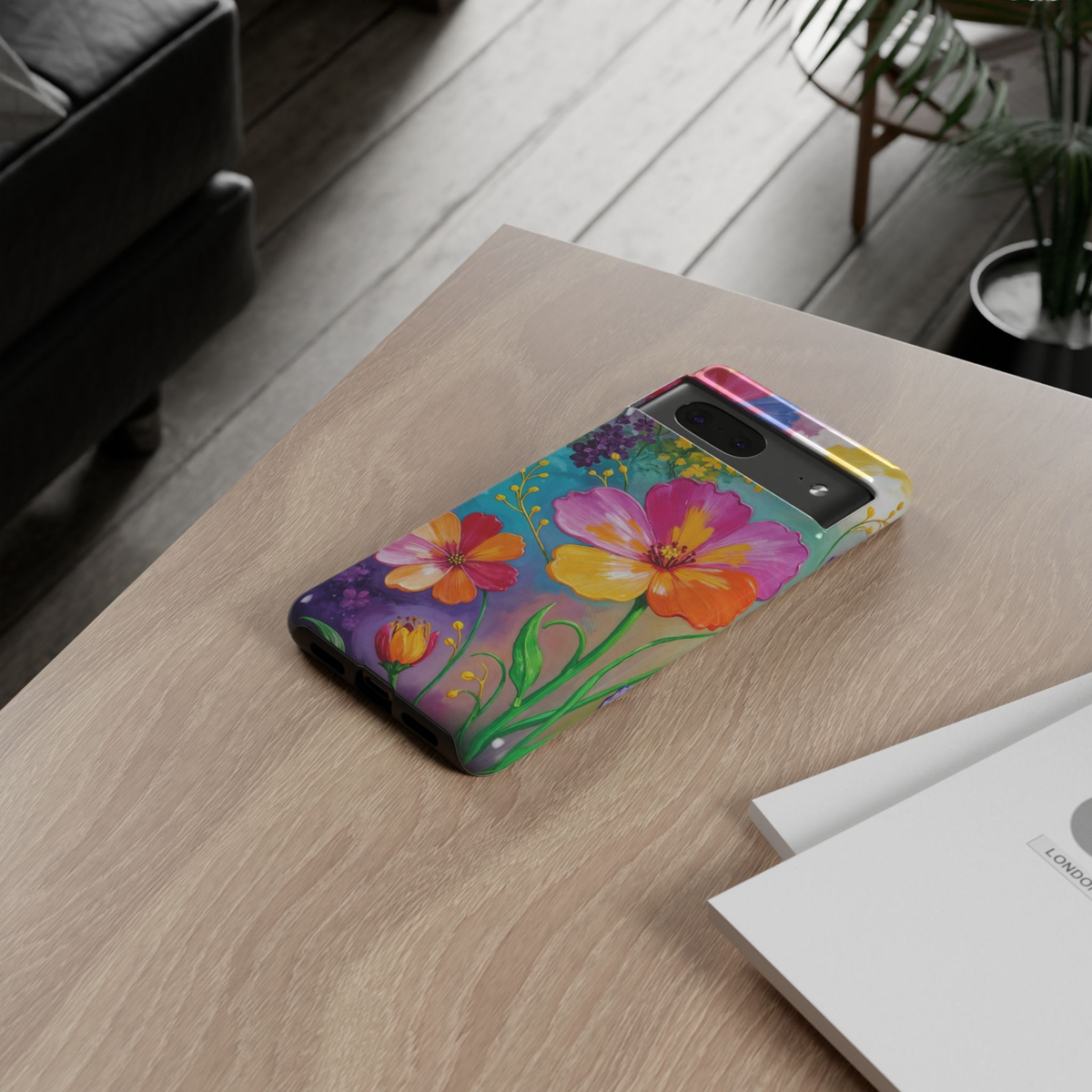 Google Pixel 10 protective phone case featuring vibrant modern flowers in pink, orange, yellow, and lavender on a colorful turquoise botanical background.