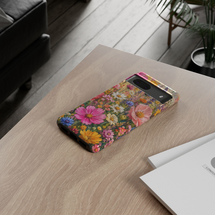 Google Pixel 10 protective phone case featuring a colorful impasto oil painting of a blooming wildflower meadow with pink cosmos, white daisies, lavender, cornflowers, and vibrant spring flowers.