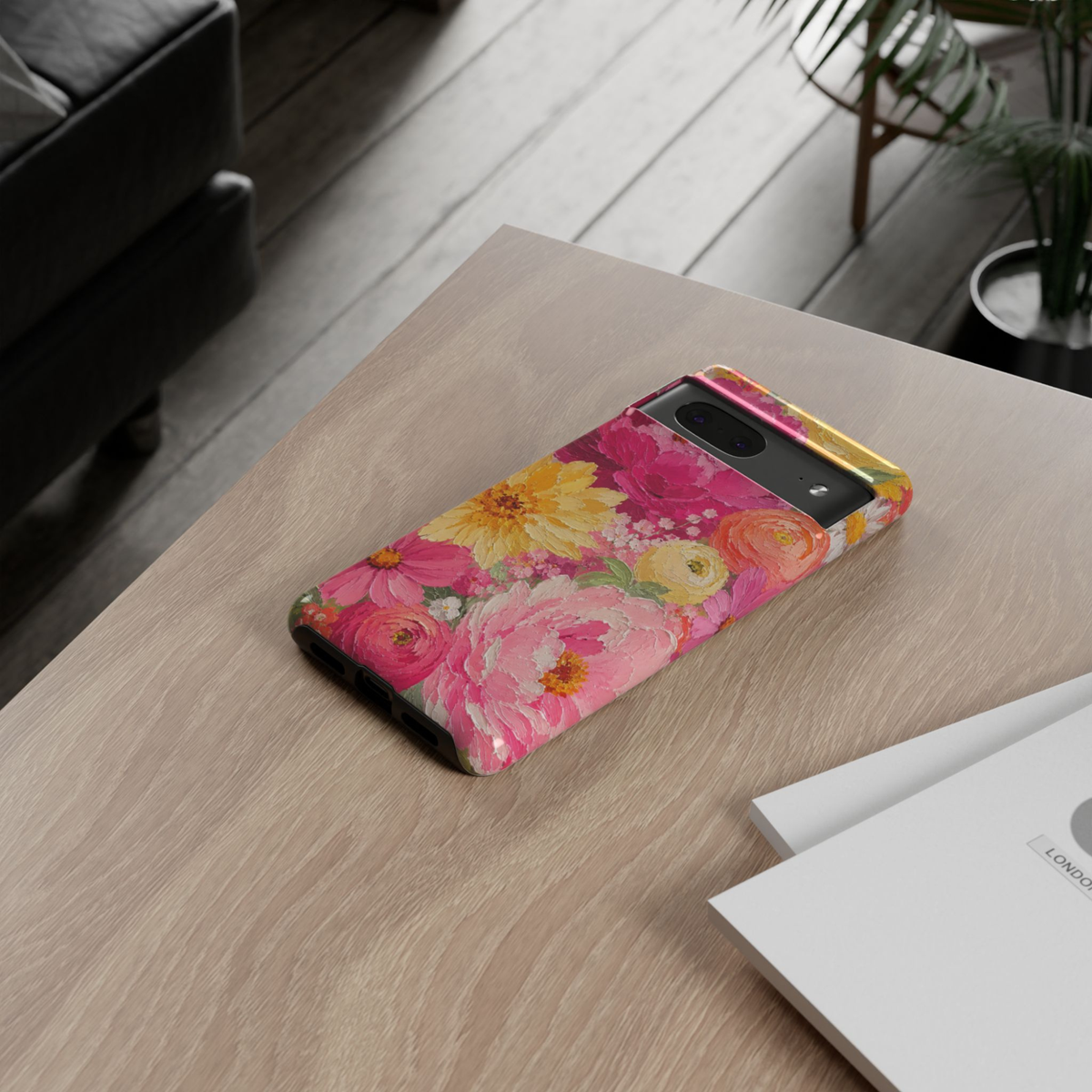 Google Pixel 10 protective phone case featuring a colorful impasto oil painting of pink peonies, yellow daisies, ranunculus, and blooming spring flowers on a vibrant floral background.