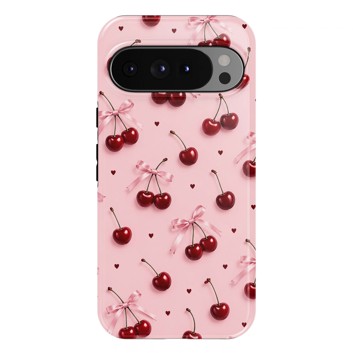 Cherry Blush Google Pixel phone case featuring glossy red cherries, soft pink satin ribbon bows and tiny burgundy hearts on a blush pink background.