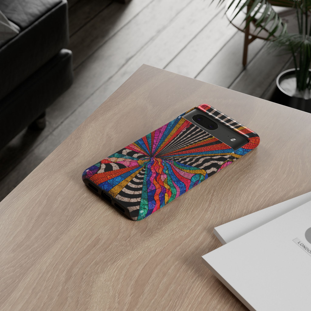 Protective Google Pixel 10 Pro phone case featuring a vibrant rainbow spiral mosaic with colorful abstract geometric patterns, black-and-white accents, and durable dual-layer protection.