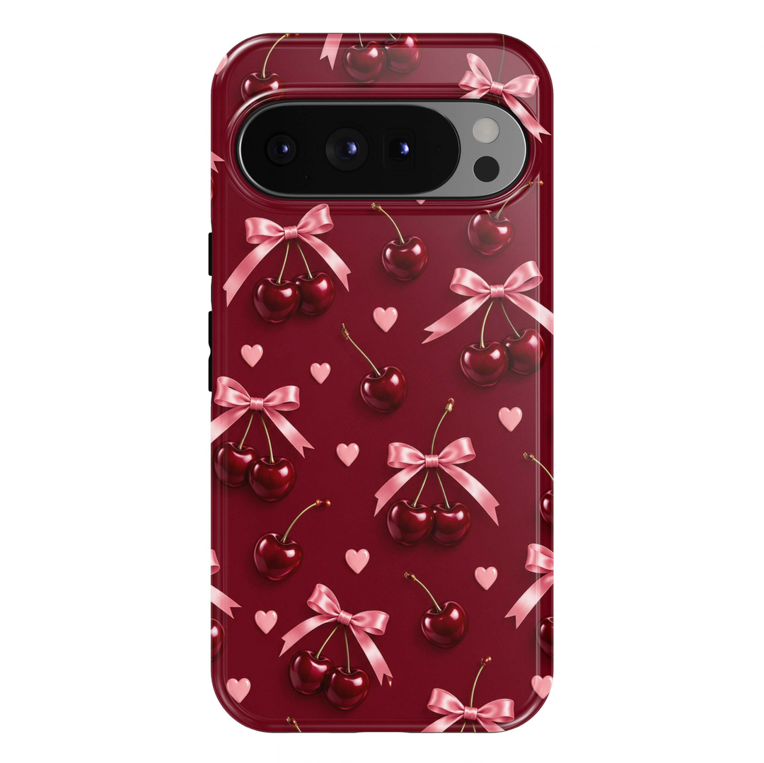 Cherry Crush Google Pixel case featuring glossy burgundy red cherries, blush pink satin bows and tiny pastel pink hearts on a rich wine-red background.