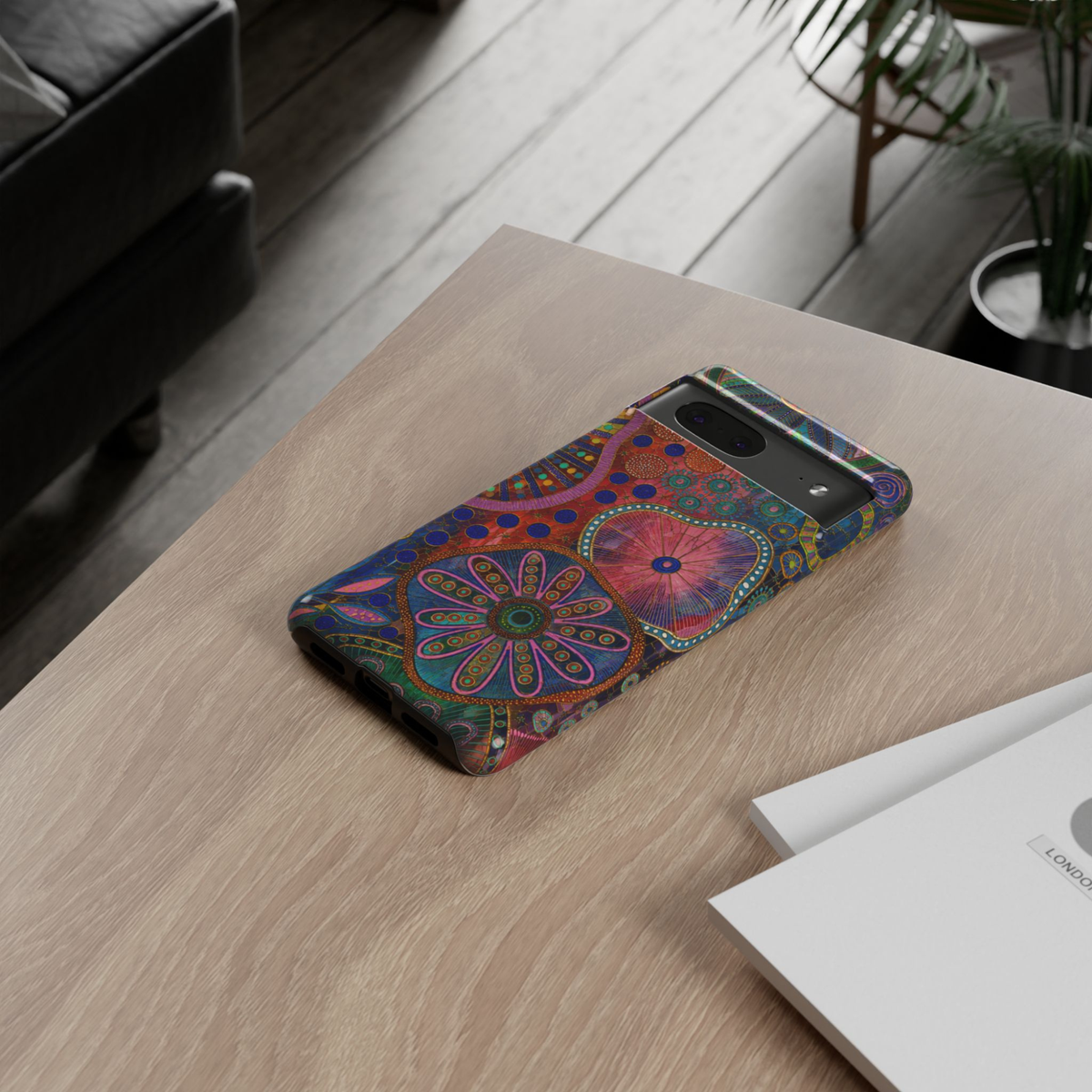 Protective Google Pixel 10 Pro phone case featuring colorful abstract floral mosaic artwork in vibrant pink, blue, teal, orange, and purple with durable dual-layer protection.