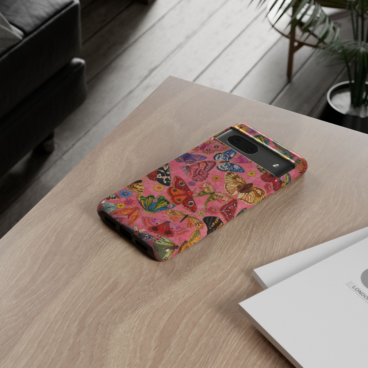 Protective Google Pixel 10 Pro phone case featuring colorful butterflies and moths on a vibrant pink mosaic background with detailed vintage-inspired artwork and dual-layer protection.