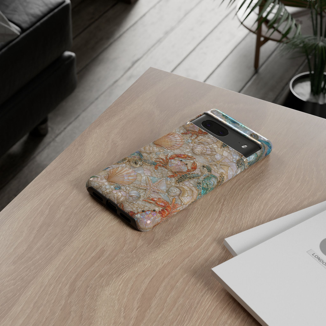 Protective Google Pixel 10 Pro phone case featuring sea turtles, crabs, seashells, pearls, and starfish in a luxurious pearlescent coastal mosaic design with durable dual-layer protection.