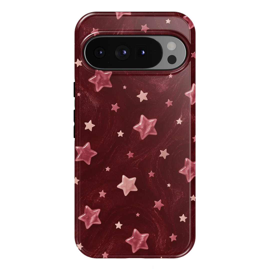 Blushing Stars Google Pixel phone case featuring glossy pink stars in assorted sizes on a deep burgundy background with a subtle printed shimmer effect.