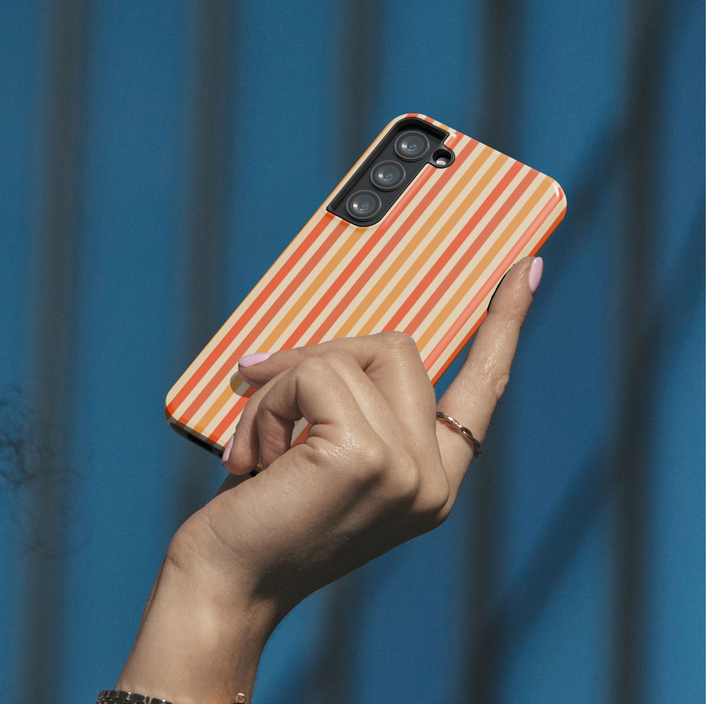 Retro orange striped Samsung Galaxy case with vertical red and orange lines. Compatible with Galaxy S24 Ultra, S24 Plus, and S23 FE. Bold, vintage aesthetic.