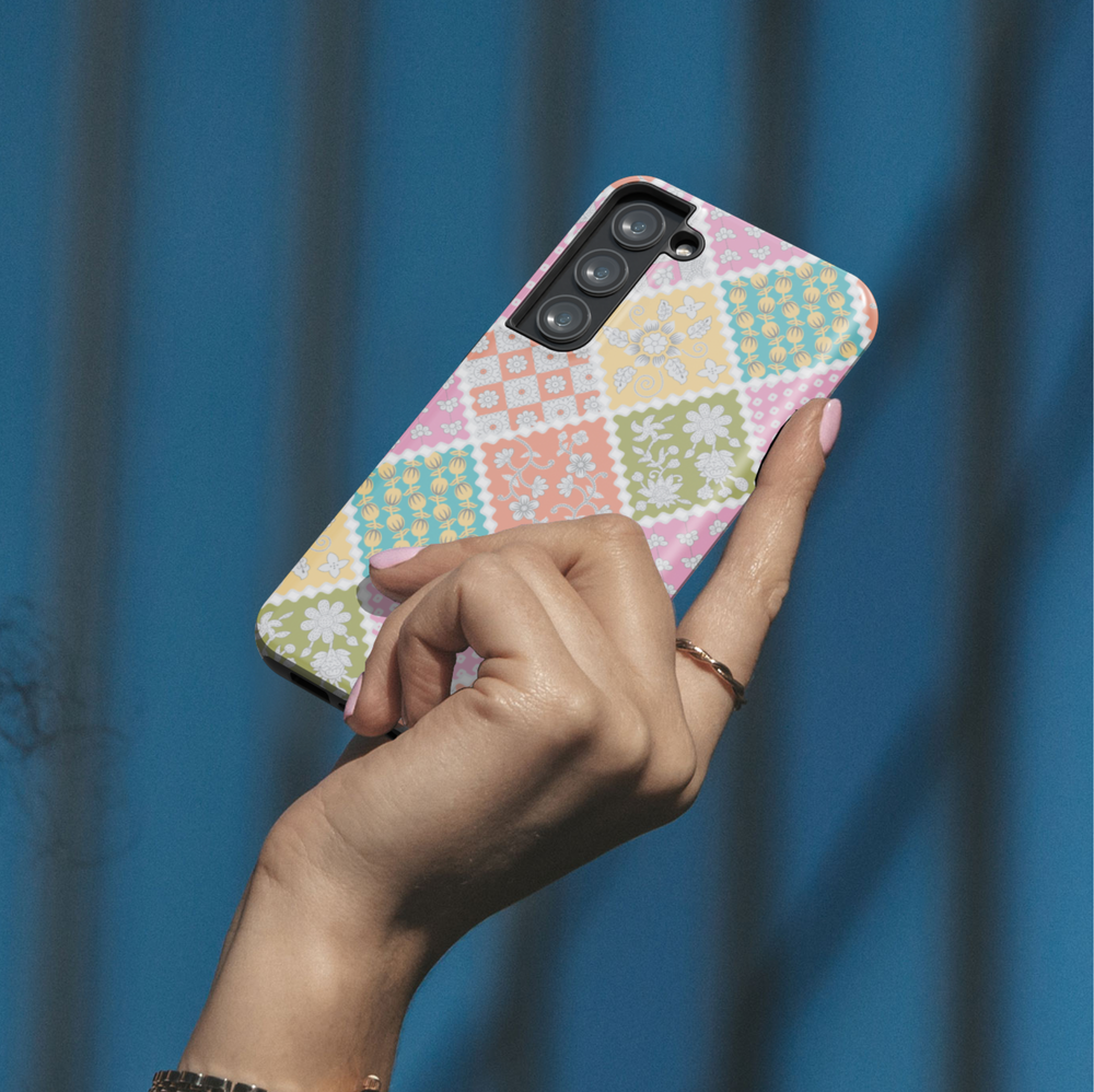 Pastel patchwork floral phone case with quilt-inspired pattern in pink, yellow, green, and blue for iPhone and Samsung