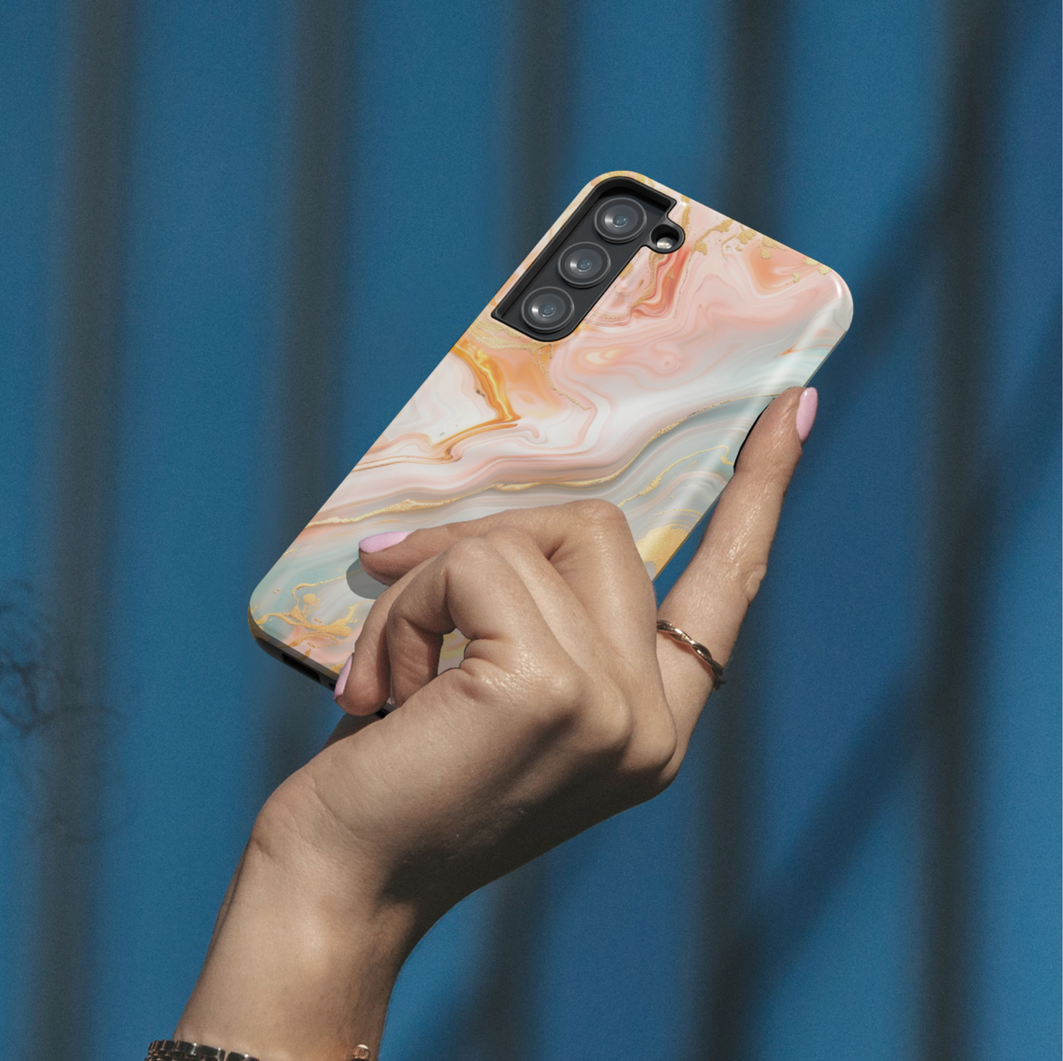 Peach and blush marble phone case with gold veining and soft luxury abstract pattern on a Samsung Galaxy tough case