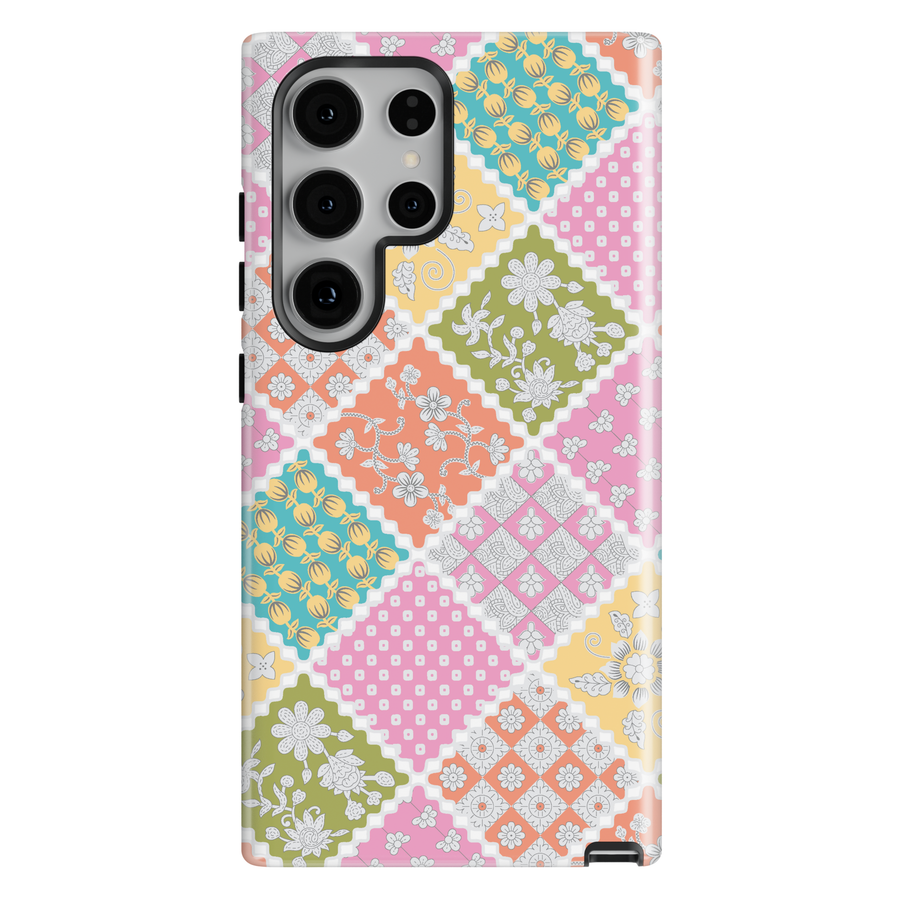 Pastel patchwork floral phone case with quilt-inspired pattern in pink, yellow, green, and blue for iPhone and Samsung