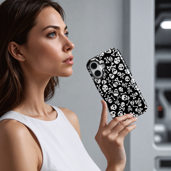 Black iPhone case with white skull and crossbones pattern, Halloween skeleton aesthetic, spooky gothic phone cover, scary skull print for iPhone 16, 15, 14, 13.