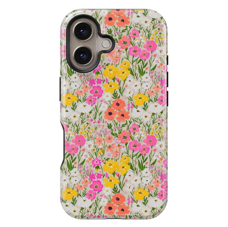 Charming iPhone case with a vibrant wildflower meadow pattern featuring hand-painted flowers in pink, yellow, coral, and white on a soft cream background.