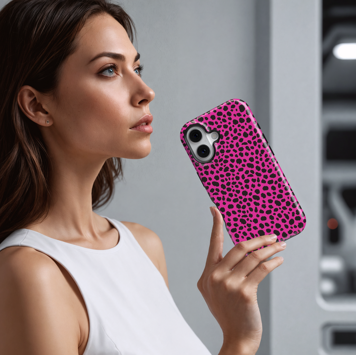 Hot pink leopard print iPhone case with bold black animal spots, designed for iPhone 16 series and MagSafe compatible, featuring a girly wild aesthetic.

