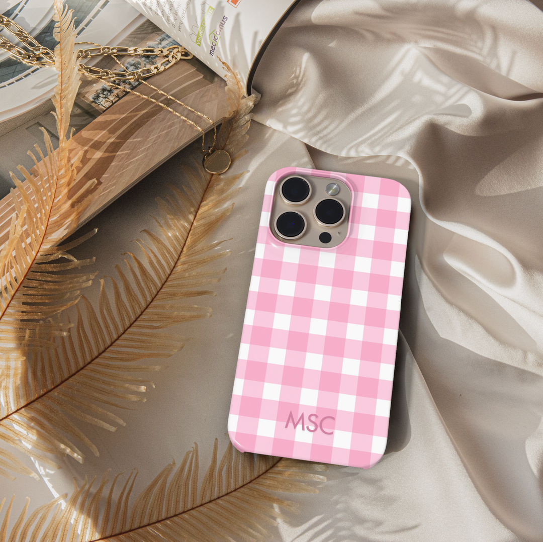 Personalized pink gingham iPhone case with custom initials. Cute checkered plaid phone cover in blush pink and white, designed for iPhone 15, iPhone 14, iPhone 13 Pro Max, and more. Aesthetic girly protective case with a trendy check pattern.