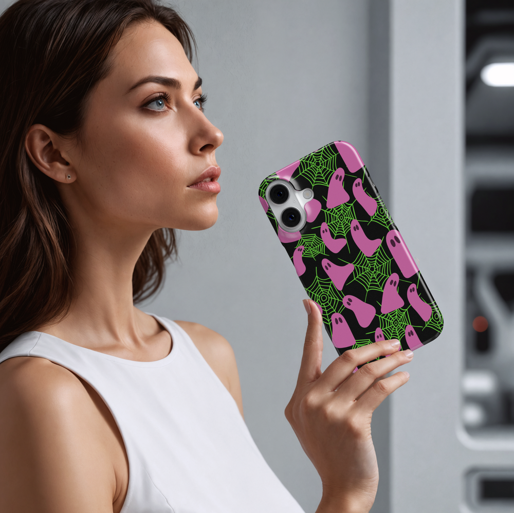 Neon Halloween iPhone case with pink ghosts and green spider webs on a black background. Cute spooky aesthetic protective phone cover for iPhone 15, iPhone 14, iPhone 13 Pro Max, and more. Fun girly ghost phone case perfect for Halloween season.