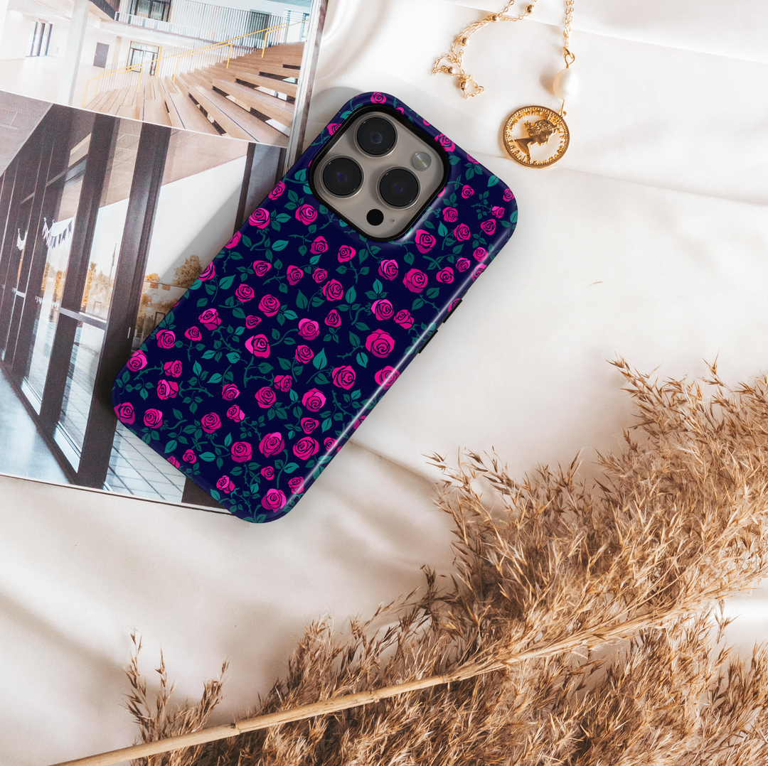 Pink rose floral iPhone case with navy blue background and green leaves. Romantic chic phone cover for iPhone 15, iPhone 14, iPhone 13 Pro Max and more. Protective slim snap case with elegant floral design.