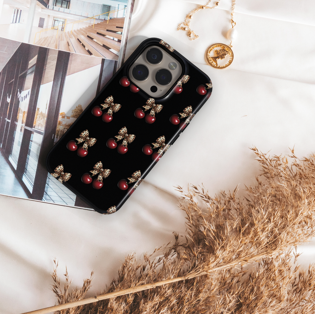 Black phone case with red cherry and leopard bow pattern, chic aesthetic animal print protective cover for iPhone and Samsung