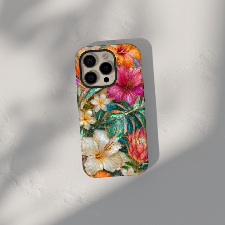 Tropical floral iPhone case featuring hibiscus flowers, plumeria blossoms, protea blooms, and vibrant monstera leaves.