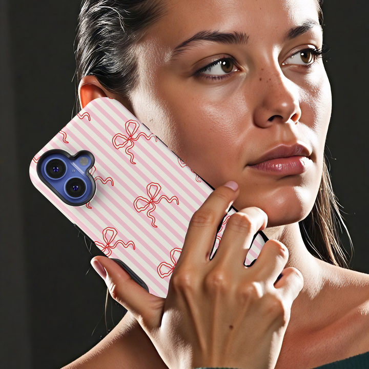 iPhone case with pink ribbon bow and polka dot pattern on soft blush background – girly aesthetic tough phone cover