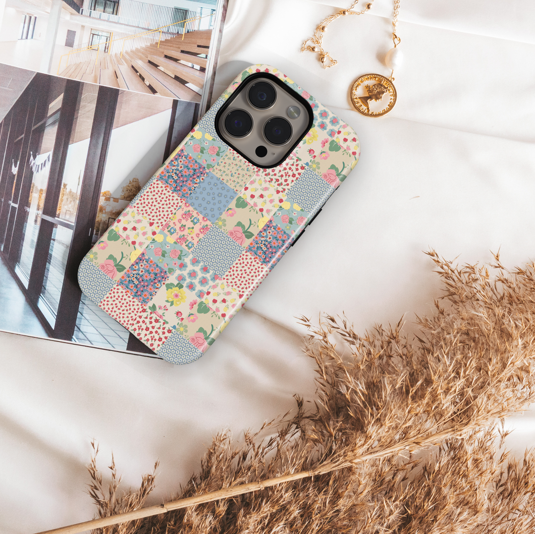 Pastel patchwork iPhone tough case with vintage floral tiles in pink, peach, green, and yellow