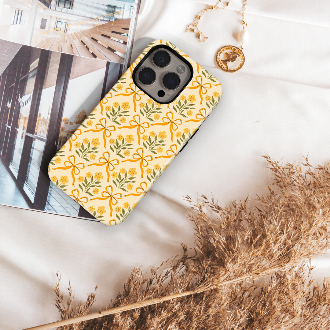 Yellow phone case with floral bow pattern, coquette vintage aesthetic design for iPhone and Samsung
