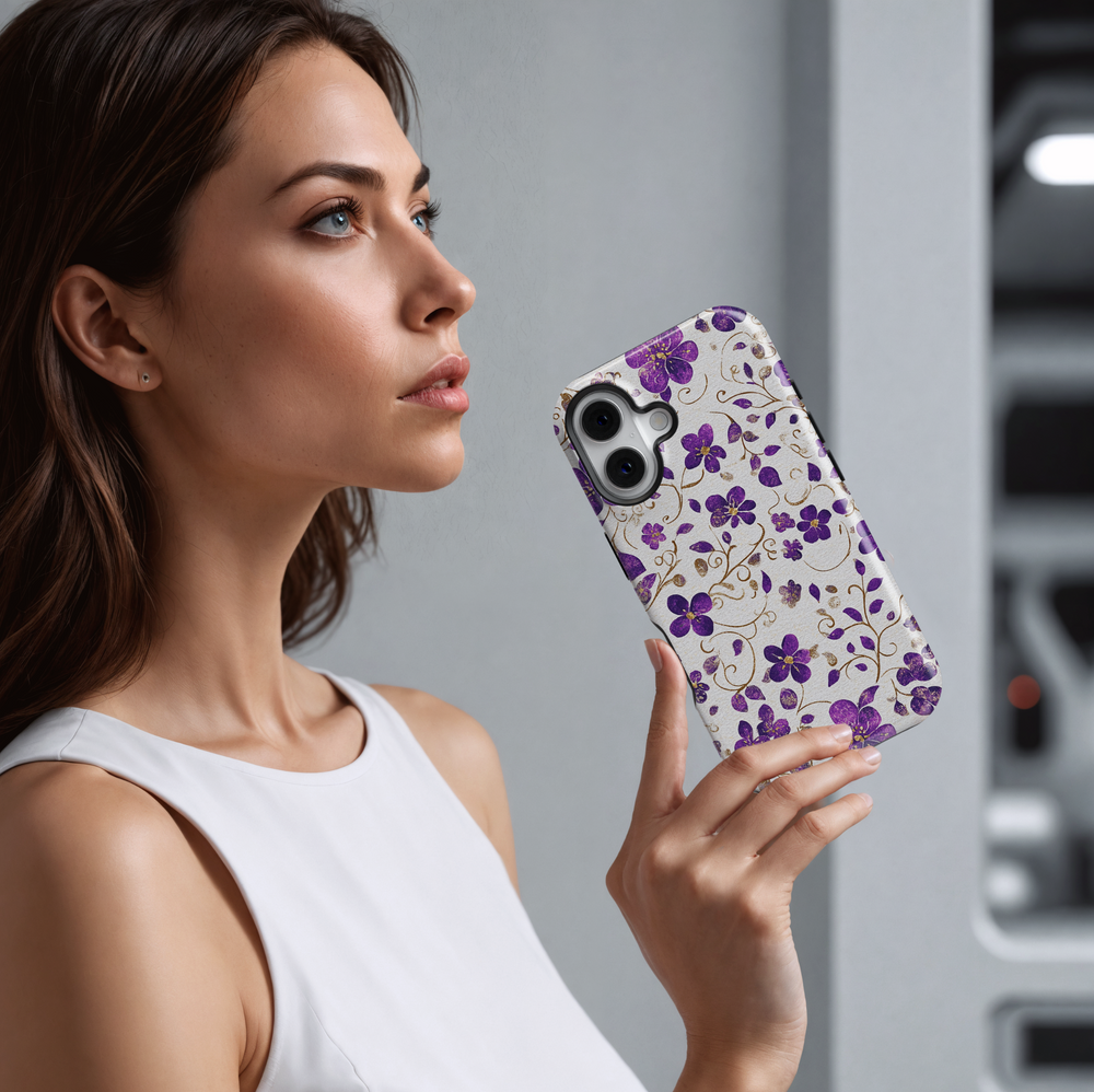 Purple floral iPhone case with shimmering gold accents and delicate vines on a light silver background. Elegant, girly, and perfect for a chic everyday look.