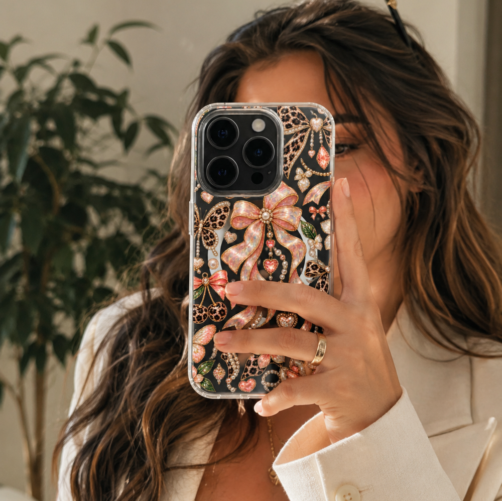 Clear MagSafe iPhone case with pink opal bows, leopard print butterflies, pearls, hearts and gold jewel-inspired details.