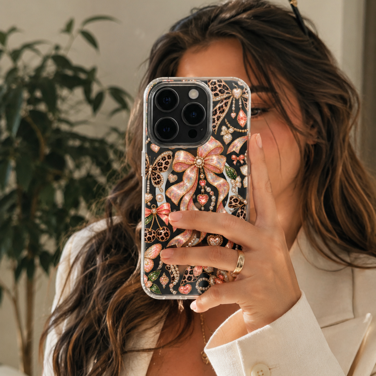 Clear MagSafe iPhone case with pink opal bows, leopard print butterflies, pearls, hearts and gold jewel-inspired details.