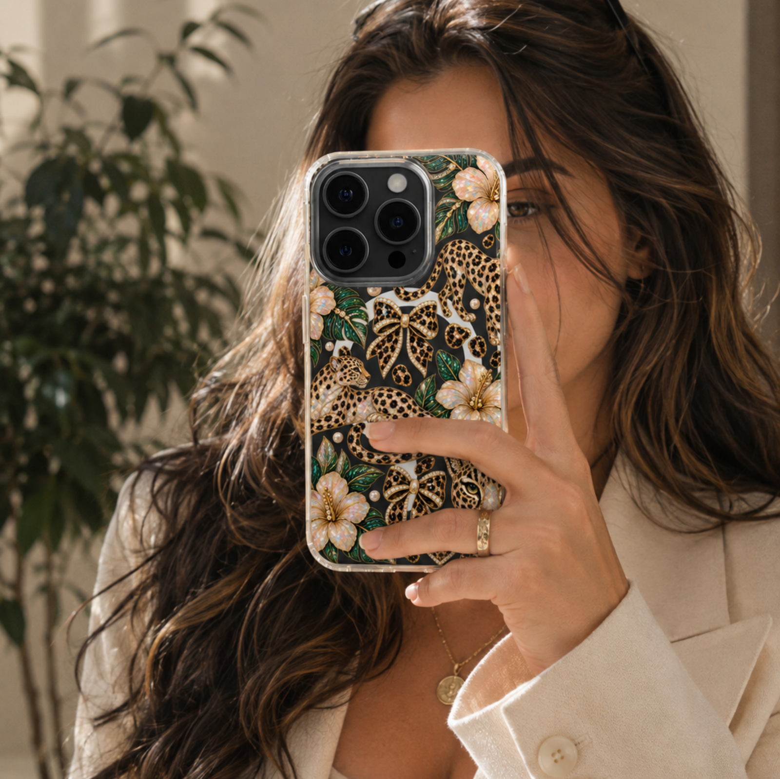 Clear MagSafe iPhone case with jeweled leopard print, tropical hibiscus flowers, leopard bows, pearls and green leaves.