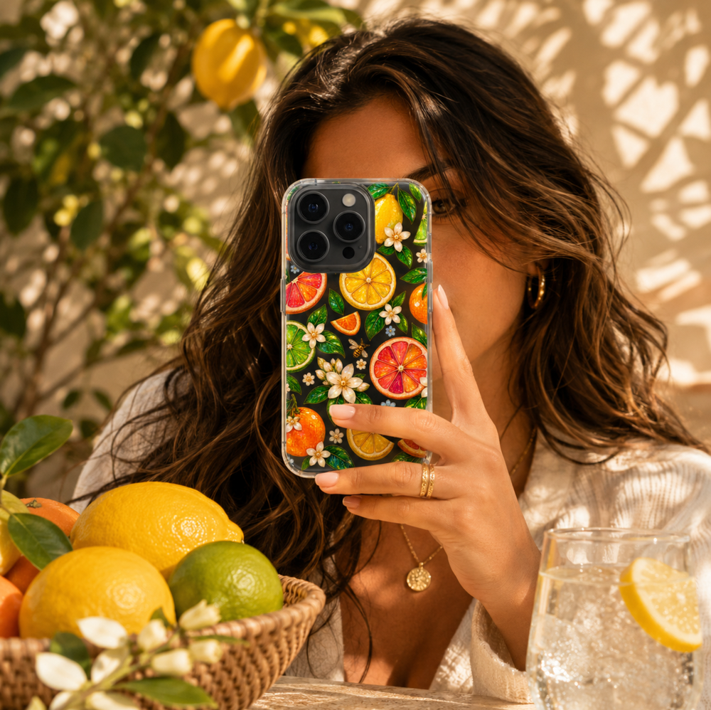Clear MagSafe iPhone case with jeweled lemons, oranges, grapefruit and limes surrounded by green leaves and delicate white flowers.