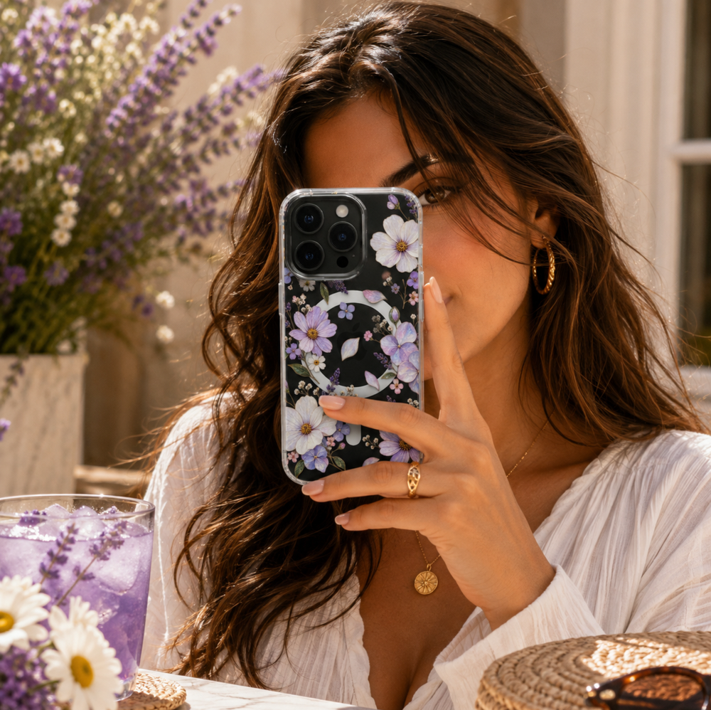 Clear MagSafe iPhone case with lavender purple and ivory wildflowers, pastel blossoms and delicate botanical details.
