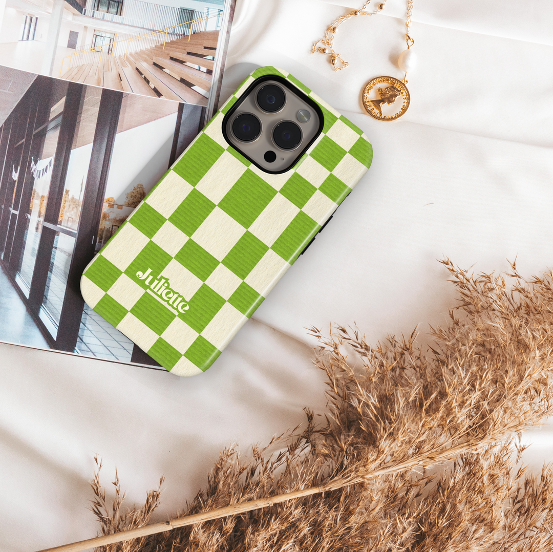 Green plaid iPhone case with oversized checkerboard design, trendy checkered phone cover in fresh green and cream, slim protective iPhone 15, iPhone 14, iPhone 13 Pro Max case. Modern aesthetic check pattern.